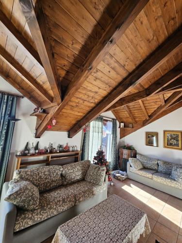 - un salon avec un canapé et un plafond en bois dans l'établissement La Vieille Douane accommodation overlooking the slopes, à Montgenèvre