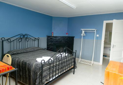 a bedroom with a black bed and a fireplace at Brackenhurst Conference and Retreat Centre in Limuru