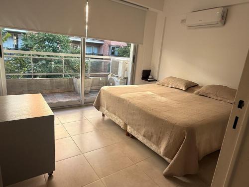a bedroom with a bed and a large window at Crucero Puerto in Buenos Aires