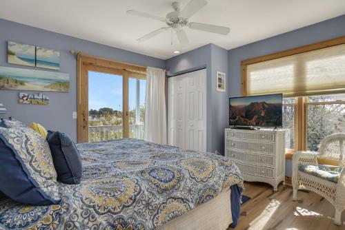 a bedroom with a bed and a television at Egret's Cove - Pet friendly w/ Hot tub! in Deep Hole