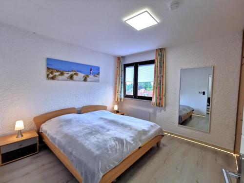 a bedroom with a large bed and a large window at Appartment 024 in Tossens in Stick