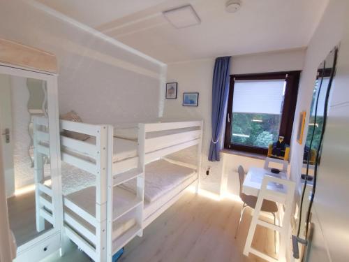 a bedroom with two bunk beds and a window at Appartment 024 in Tossens in Stick
