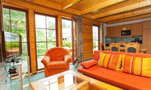 a living room with a couch and a tv at Ferienhaus Nr 3 Sporthotel Oberhof in Oberhof