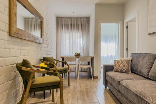 a living room with a couch and a table at Novus Homes Barcelona Santa Eulalia in Hospitalet de Llobregat
