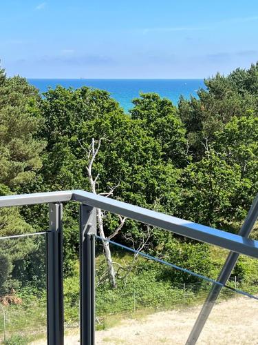 a view of the ocean from a balcony at FeWo Prora - Wellenblick inklusive Strandkorb in Binz