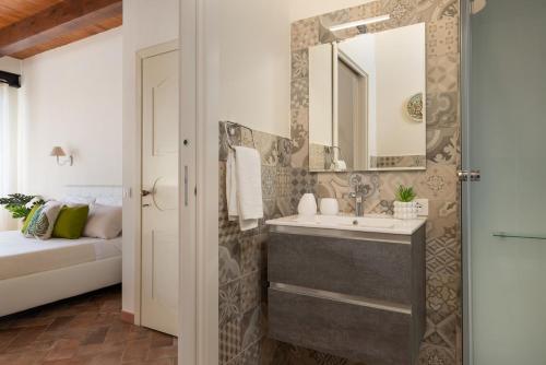 a bathroom with a sink and a mirror at Villa Le Cicale in Montecatini Val di Cecina