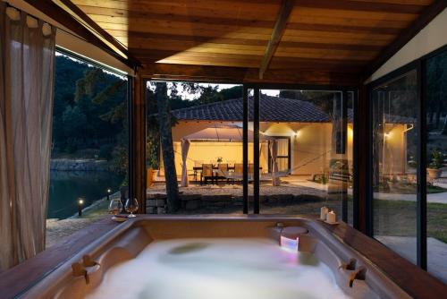 a bath tub in front of a house with a view at Villa Le Cicale in Montecatini Val di Cecina