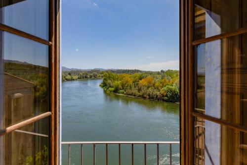 a view of a river from a window at Palacio de Miravet, casa monumento y galería de arte frente al río Ebro in Miravet
