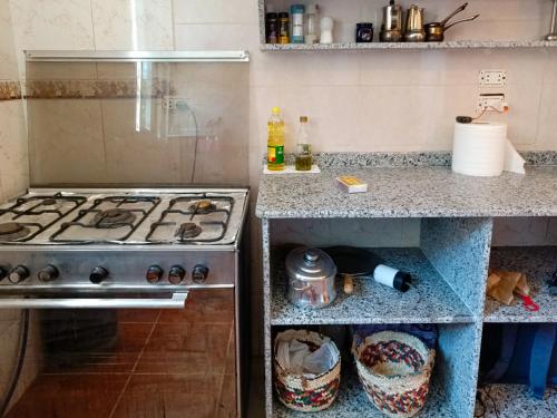 a kitchen with a stove and a counter top at Bonita Chillhouse in Aswan