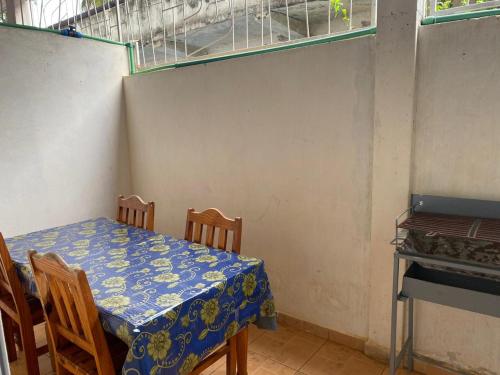 a table in a room with a table and chairs at Residence Kathyly in Diego Suarez