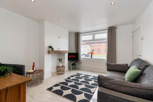 a living room with a couch and a fireplace at The Cozy Terrace in Guisborough