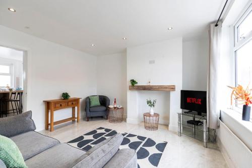 a living room with a couch and a tv at The Cozy Terrace in Guisborough