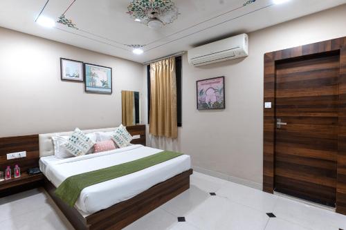 a hotel room with a bed and a window at Rawla Udaipur - A Unit of UBEO HOTELS in Udaipur