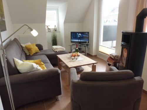 a living room with two couches and a table at Ostseebrise 14 - Großenbrode in Grossenbrode