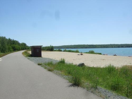 een weg naast een strand naast een waterlichaam bij Fewo im Neuseenland EG in Rötha