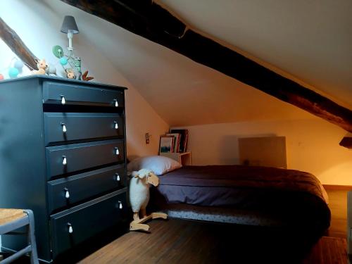 - une chambre avec un lit et une commode noire dans l'établissement 90m2 3ch duplex cœur village 10 mn piste free navette, à Bolquère-Pyrénées 2000