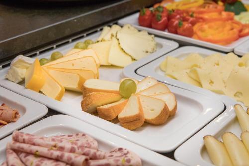 a tray of different types of cheese and meats at Design Hotel Frauenschuh in Salzburg