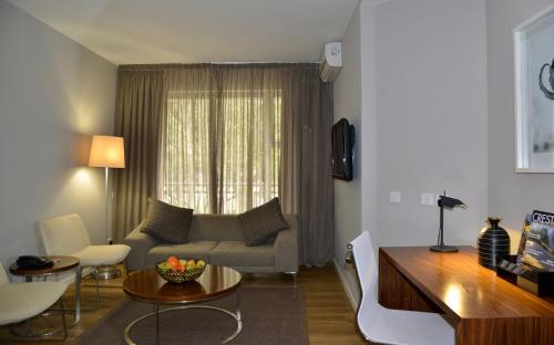 a living room with a couch and a table at Cresta Lodge Gaborone in Gaborone