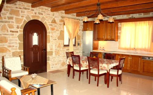a kitchen and dining room with a table and chairs at Villa Fabrika in Vóroi