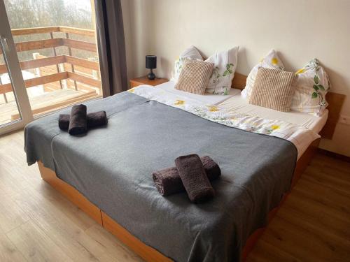 a bedroom with a bed with two towels on it at Chata Lenka Mýto pod Ďumbierom 657 in Mýto pod Ďumbierom