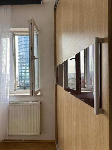 a room with two windows and a radiator at BT Apartments 2 in Pristina