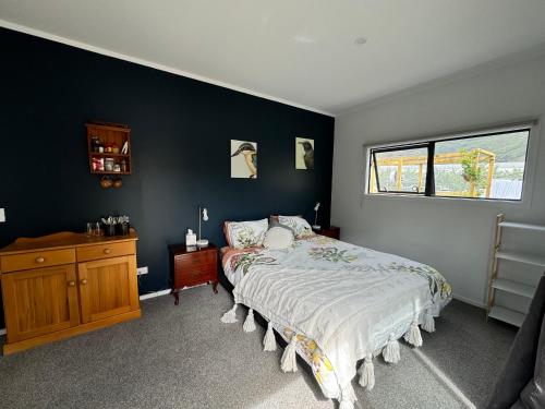 a bedroom with a bed and a wooden dresser at Comfortable Barn Stay on Private Rural Property in Cromwell in Cromwell