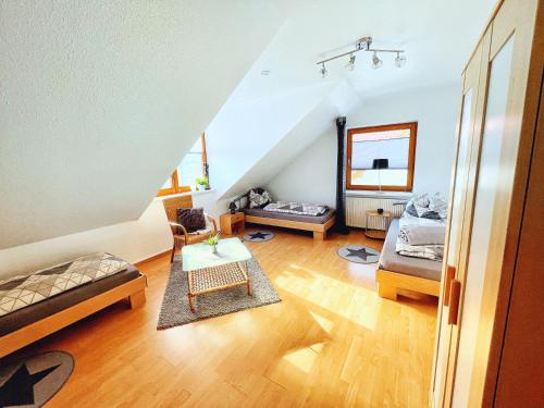a living room with two beds and a table at Ferienwohnung Marberth in Hildesheim