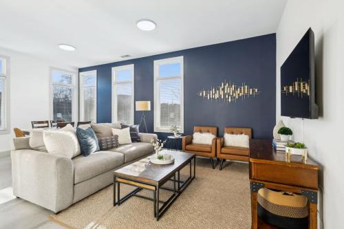 a living room with a couch and a table at Modern Townhome 2 Miles South of Downtown and Broadway Ave in Nashville