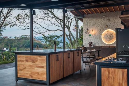 an outdoor kitchen with wooden cabinets and a counter top at Monteclaro Campestre - En Sopetran in Sopetran