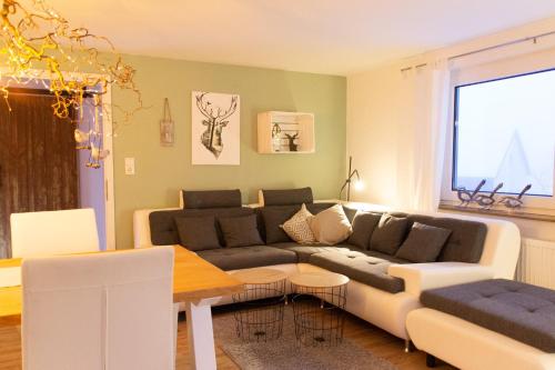 a living room with a couch and a table at Hof Timmermann - Spatzennest in Ottenstein