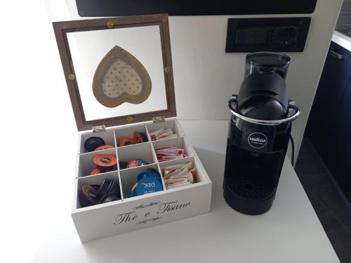 a cupboard with a picture and a blender on a counter at La Casa di Saretta in Trieste