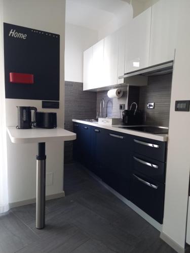 a kitchen with black and white cabinets and a counter at La Casa di Saretta in Trieste