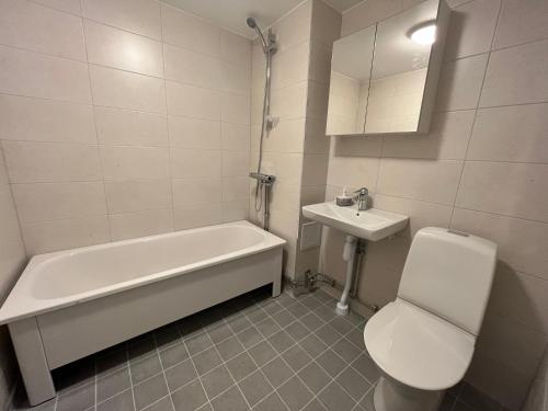 a bathroom with a tub and a toilet and a sink at Cozy shared home for female in Stockholm in Stockholm