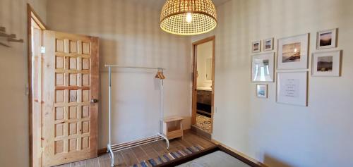 a hallway with a shower and a door and a chandelier at CASA COLIBRI - BEACH LIVING AT ITS BEST in Ensenada