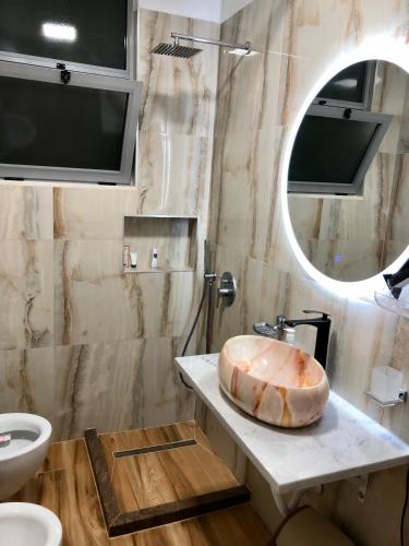 a bathroom with a sink and a large tub on a counter at Beach Apartments Durres in Durrës