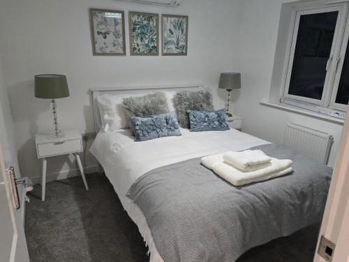 a bedroom with a bed with two towels on it at Glynn House in Newport