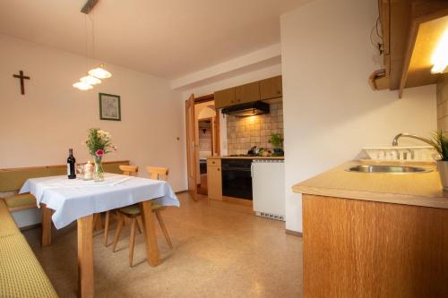 a kitchen with a table with a white table cloth at Christof,s Ferienwohnung WILD232 in Oberau
