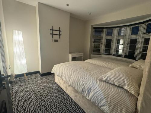 a bedroom with two beds and a window at Luxury 3bed Hot Tub and sauna facilities amazing location in Birmingham