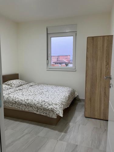 a bedroom with a bed and a window at Airport Art Villa in Čukarica