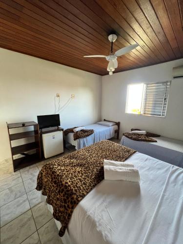 Ein Bett oder Betten in einem Zimmer der Unterkunft Pousada Orla do Sol