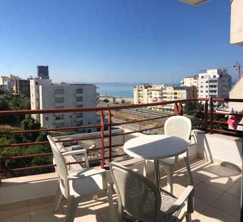 a balcony with chairs and a table and a view at Beach Apartments Durres in Durrës