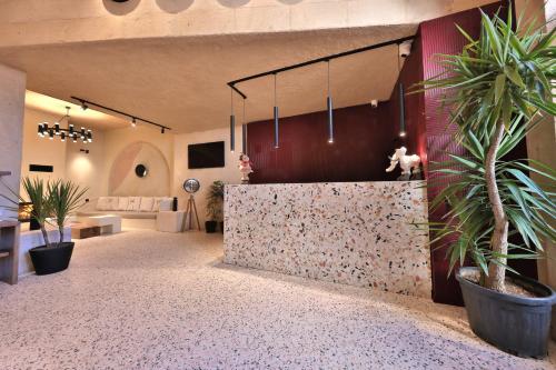 a room with potted plants and a wall at Simurg Cave House in Urgup