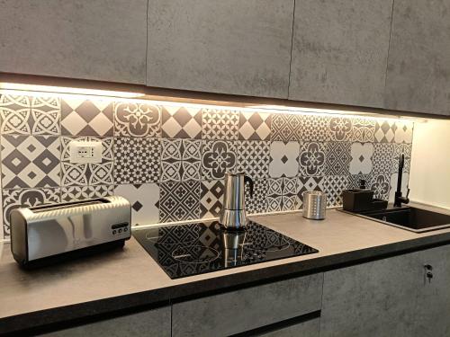 a kitchen with a counter with a toaster and a sink at Ancient Rome Colosseum modern and bright apartment in Rome