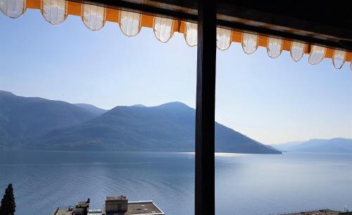 a view of a lake from a window at "Vista dolce" in Brissago