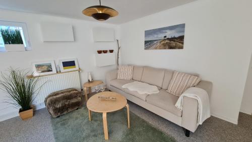 a living room with a couch and a table at Ferienhaus Boje14a in Haffkrug