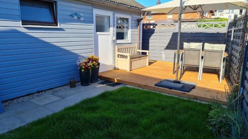 a porch of a house with a wooden deck at Ferienhaus Boje14a in Haffkrug