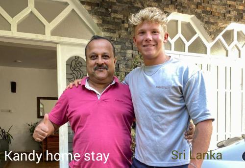 a man standing next to a man in front of a house at Kandy Home stay in Katugastota