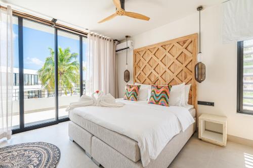 a bedroom with a large bed and a large window at Van der Valk Plaza Beach & Dive Resort Bonaire - ALL INCLUSIVE in Kralendijk