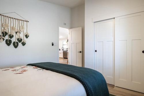 a bedroom with a bed with a green blanket on it at Tumbleweed charm of the Bus Stop Saloon in Cave Creek