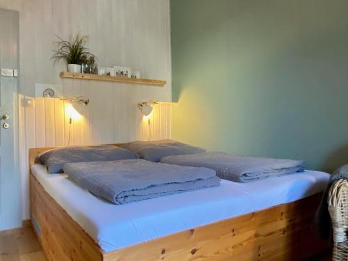 a bed with two pillows on it in a room at Haus AchternDiek Strandhafer in Dahme